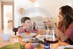 Family with a little child sitting together for lunch