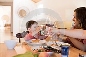 Family with a little child sitting together for lunch