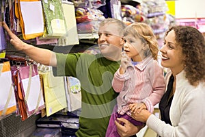 Family with little girl buy bedding in supermarket