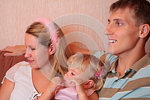 Family with little girl in room