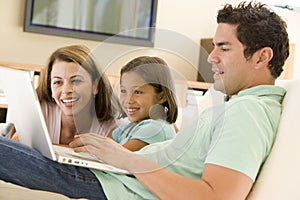 Family in living room with laptop