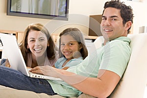 Family in living room with laptop