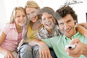 Family in living room with remote control