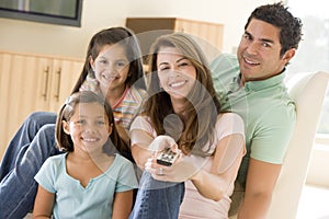 Family in living room with remote control