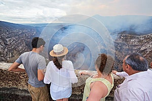 Family look at volcano crater
