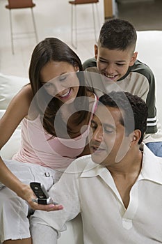 Family looking on cell phone