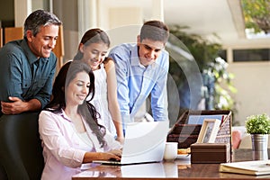 Family Looking At Laptop Together