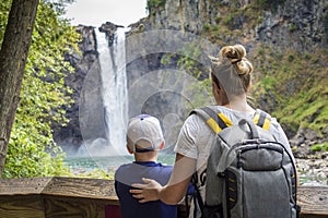 Family looking at a scenic waterfall on a hike together