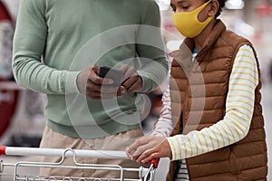 Family Looking at Shopping List at Smartphone