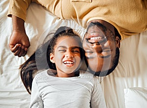 Family, love and black man with girl or child lying in bed in a home smiling and bonding by having fun. Top, dad and