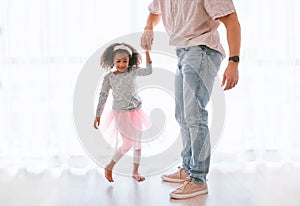 Family, love and father dance with girl, having fun and bonding in home. Smile, happy and parent with child or kid