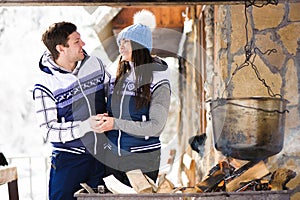 Family in love laughing and cooking in the winter outdoors. Bonfire, barbecue, bowler.