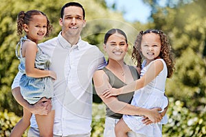 Family is love, smiles and everything in between. Portrait of a happy young family enjoying a fun day out at the park.