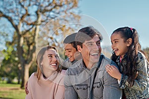 Family love is a special kinda love. a happy young enjoying spending time together in the park.