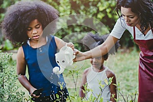 Family lovely gardening watering green plant activity with children during Stay at Home to reduce the outbreak of the Coronavirus