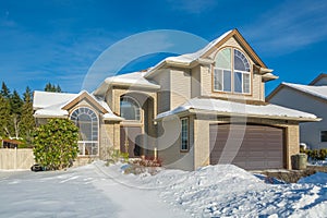 Family luxury house with front yard in snow