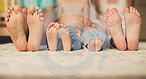 Family lying in bed together-focus on your feet.