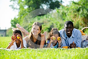 Family lying on blanket on picnic