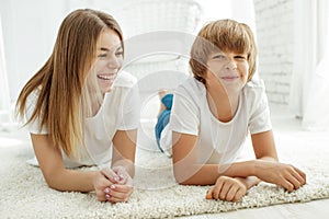 Family lying on the carpet at home