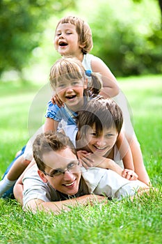 Family lying on grass