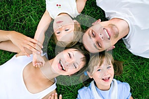 Family lying on grass