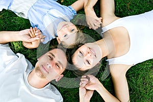 Family lying on grass