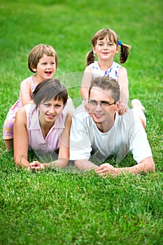 Family lying on grass