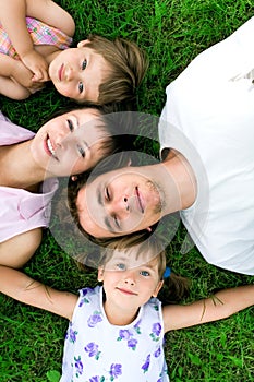 Family lying on grass