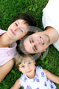 Family lying on grass