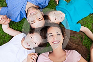 Family lying on grass