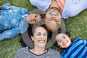 Family lying on grass