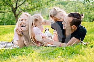 Family lying on grass in countryside