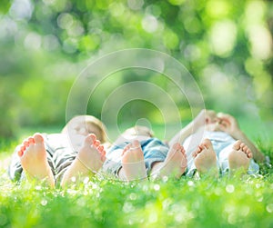 Family lying on green grass