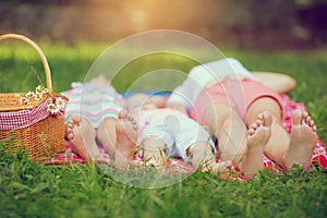 Family lying on green grass in the park