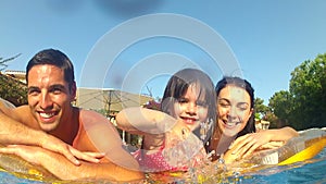 Family lying on inflatable airbed