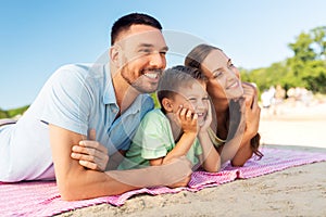 family lying on summer beach
