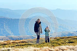 Family make photo on autumn mountain plateau