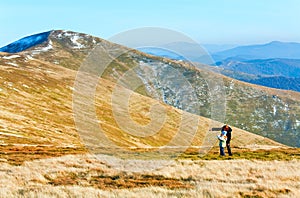 Family make photo on autumn mountain plateau