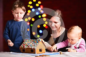 Family making gingerbread house