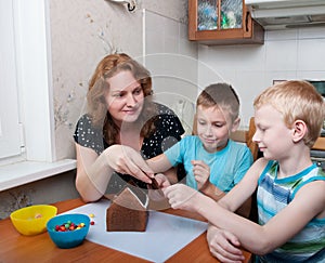Family making gingerbread house