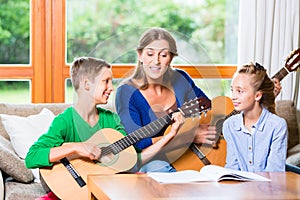 Family making music with guitar