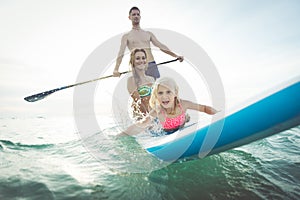 Family making paddle surf in the ocean