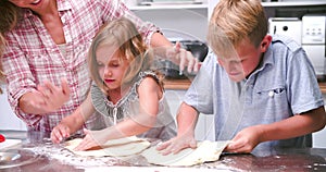 Family Making Pizza In Kitchen Together