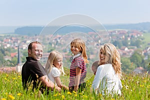 Family on meadow in spring or early summer