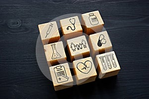 Family medicine and health insurance concept. Wooden cubes on desk.