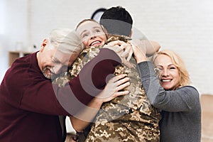 The family meets a man in camouflage at home.