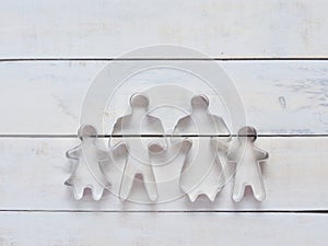 Family metal cookie or biscuit cutter used to cut dough in particular shape composed of father, mother, brother, and sister over r