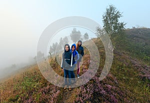 Family on misty morning dew mountain meadow