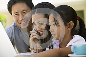 Family With Mobilephone And Laptop