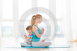 Family mother and child daughter are engaged in meditation and y